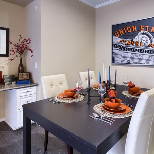 a dining room with a table and chairs