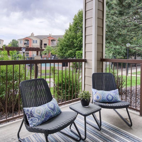 a patio with chairs and a table