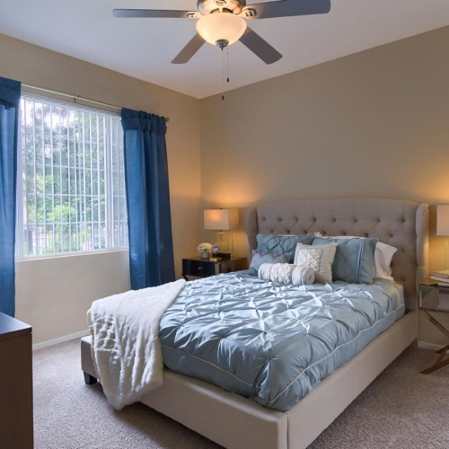 a bedroom with a bed and a fan